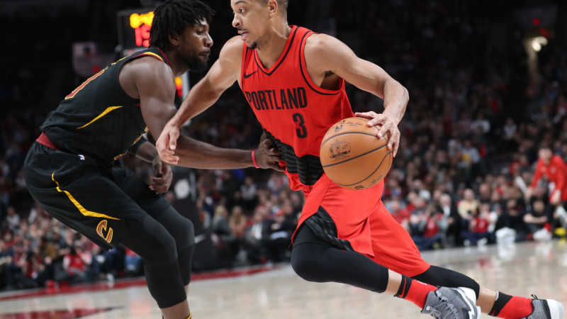 Portland Trail Blazers guard CJ McCollum and Cleveland Cavaliers guard John Holland