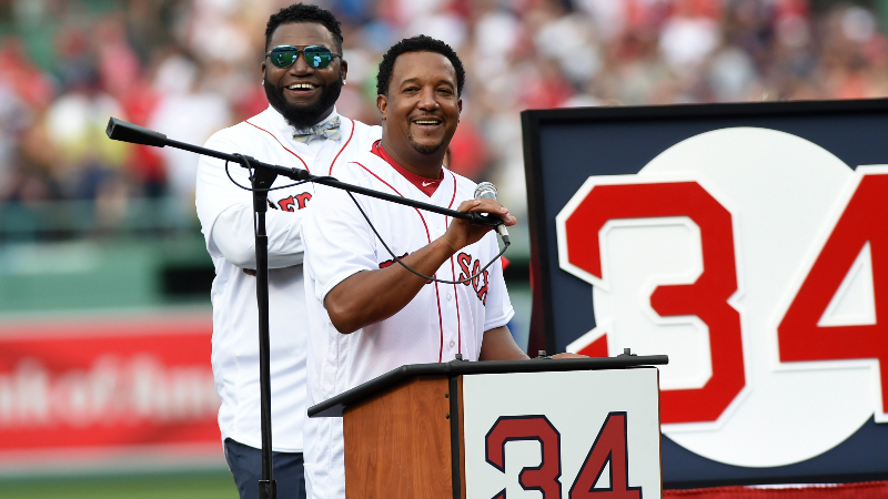 Boston Red Sox former pitcher Pedro Martinez speaks during ceremonies for David Ortiz (behind Martinez)