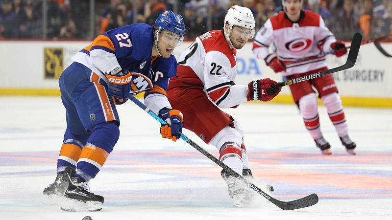 New York Islanders left wing Anders Lee and Carolina Hurricanes defenseman Brett Pesce