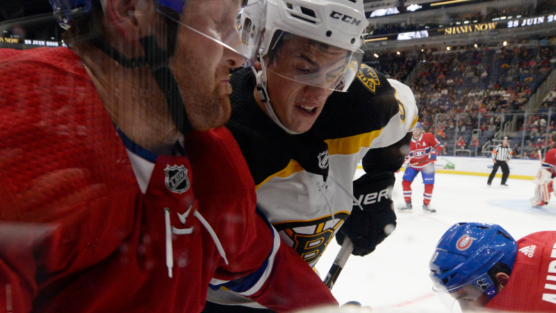 Montreal Canadiens defenseman Karl Alzner (left) and Boston Bruins forward Jack Studnicka