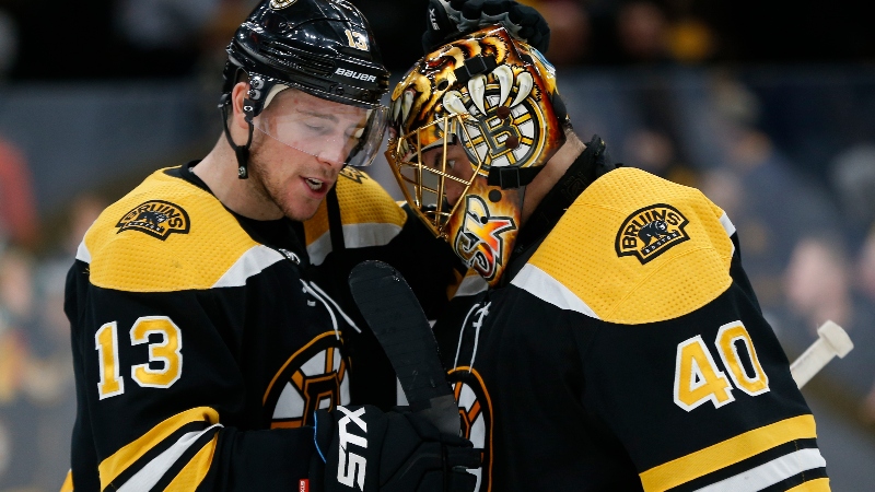 Boston Bruins center Charlie Coyle (13) and goaltender Tuukka Rask (40)