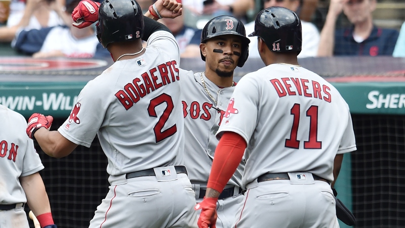 Boston Red Sox shortstop Xander Bogaerts (2), right fielder Mookie Betts (middle) and third baseman Rafael Devers (11)