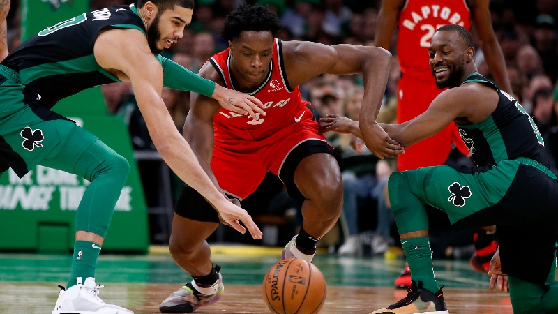 Boston Celtics forward Jayson Tatum (left) and guard Kemba Walker (right) and Toronto Raptors forward OG Anunoby (center)