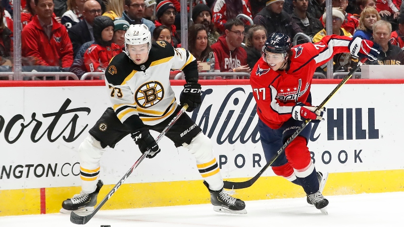 Boston Bruins defenseman Charlie McAvoy (73) and Washington Capitals right wing T.J. Oshie (77)
