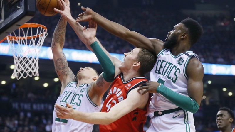 Toronto Raptors center Jakob Poeltl and Boston Celtics forwards Daniel Theis and Jaylen Brown