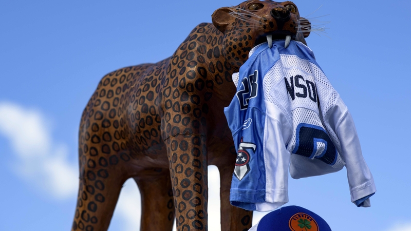 Jaguars mascot holds a Titans jersey
