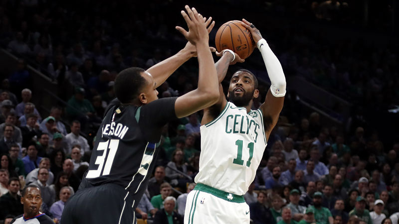 Milwaukee Bucks forward John Henson and Boston Celtics guard Kyrie Irving