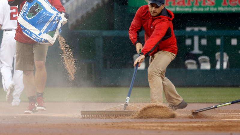 Field workers put dirt down in the infield