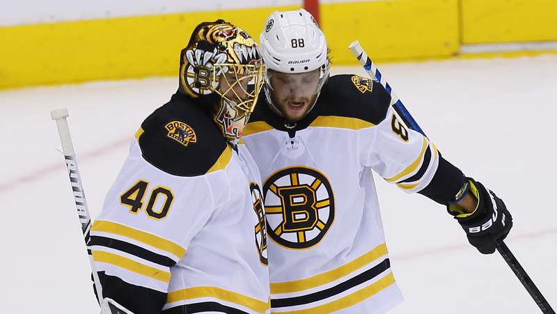 Boston Bruins' Tuukka Rask and David Pastrnak