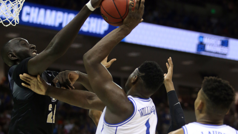NBA center Tacko Fall (24) and forward Zion Williamson (1)