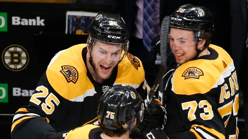 Boston Bruins defenseman Brandon Carlo (25) and defenseman Charlie McAvoy (73)