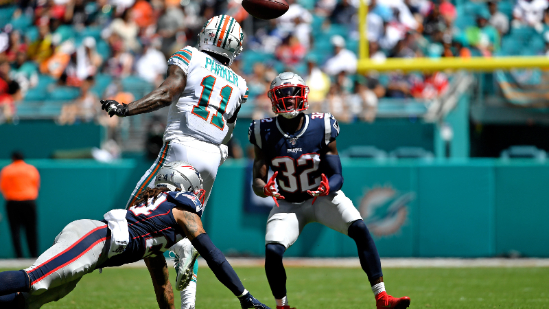 New England Patriots free safety Devin McCourty (32) and Miami Dolphins wide receiver DeVante Parker (11)