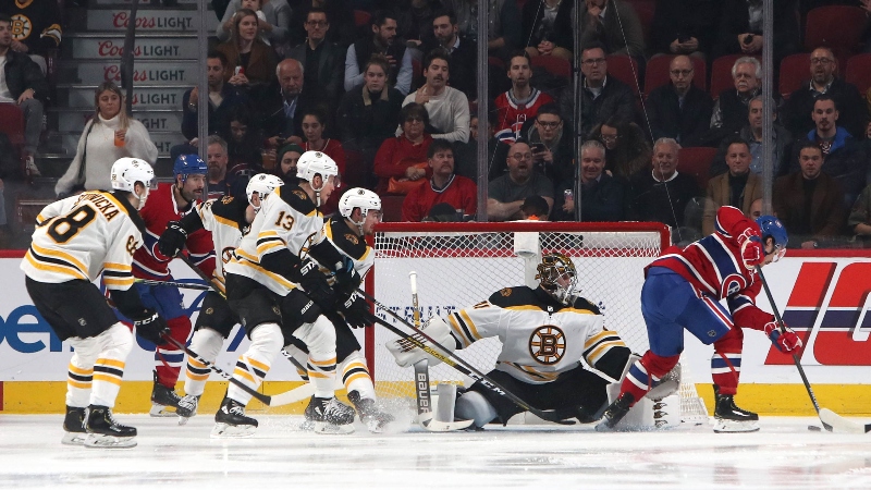 Montreal Canadiens left wing Charles Hudon (54) and Boston Bruins goaltender Jaroslav Halak (41)