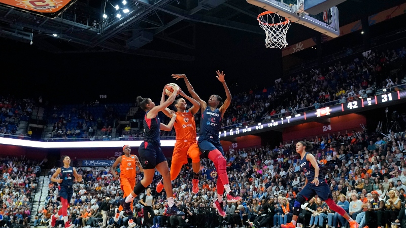 Connecticut Sun forward Alyssa Thomas (25) and Washington Mystics guard Shatori Walker-Kimbrough (32) and guard Natasha Cloud (9)