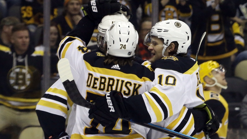 Boston Bruins left wing Anders Bjork (10) and Bruins left wing Jake DeBrusk (74)