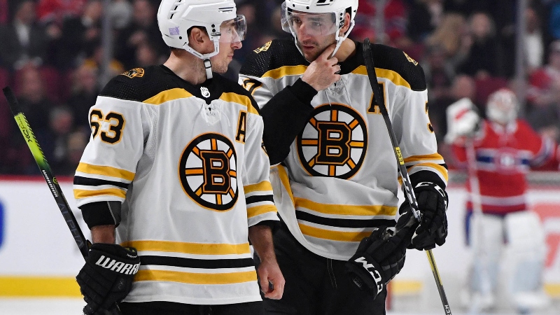 Boston Bruins forward Brad Marchand (63) and teammate Patrice Bergeron (37)