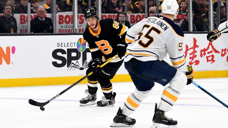 Boston Bruins right wing David Pastrnak (88) and Buffalo Sabres defenseman Rasmus Ristolainen (55)