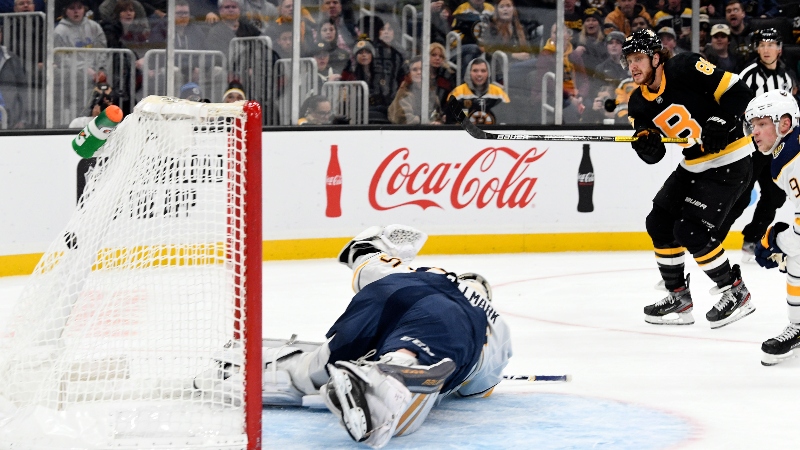 Boston Bruins right wing David Pastrnak (88) and Buffalo Sabres goaltender Linus Ullmark (35)