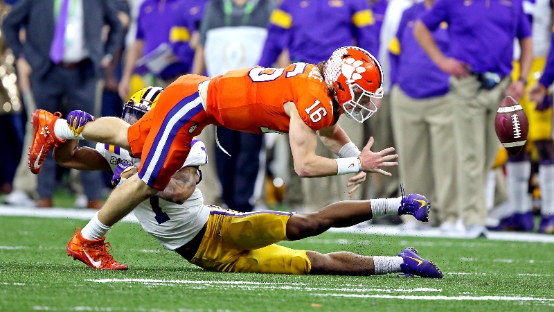 Clemson Tigers quarterback Trevor Lawrence (16) and LSU Tigers cornerback Kristian Fulton (1)