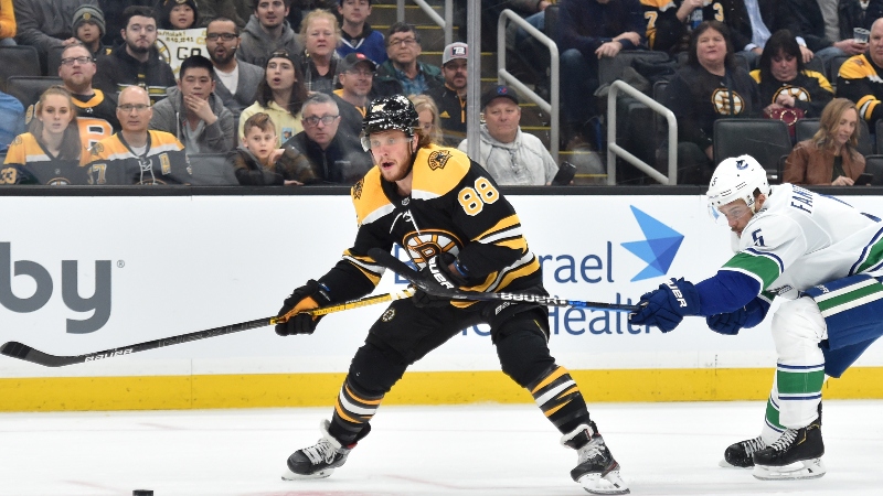 Boston Bruins right wing David Pastrnak (88) and Vancouver Canucks defenseman Oscar Fantenberg (5)