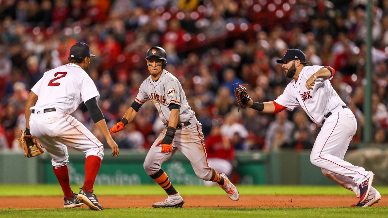 San Francisco Giants second baseman Mauricio Dubon (19), Boston Red Sox first baseman Mitch Moreland (18) and Red Sox shortstop Xander Bogaerts