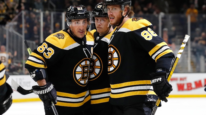 Boston Bruins right wing David Pastrnak (88), left wing Brad Marchand (63) and defenseman Torey Krug (47)
