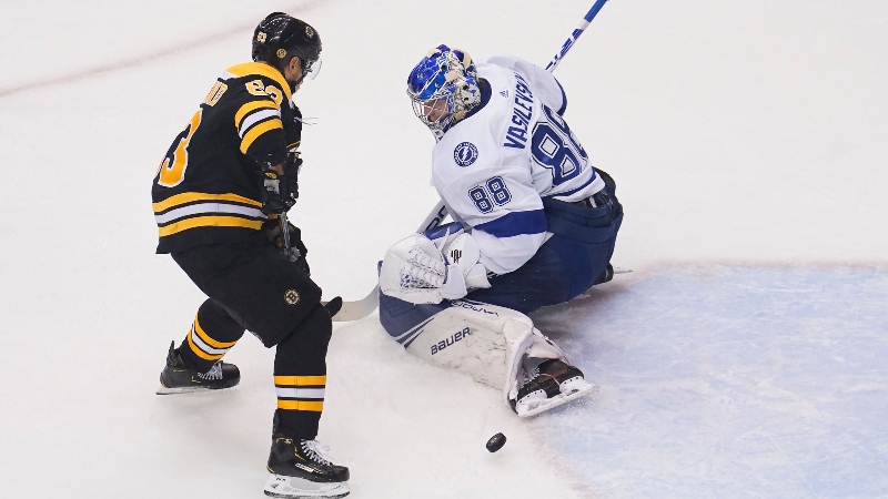 Boston Bruins left wing Brad Marchand (63) and Tampa Bay Lightning goaltender Andrei Vasilevskiy (88)