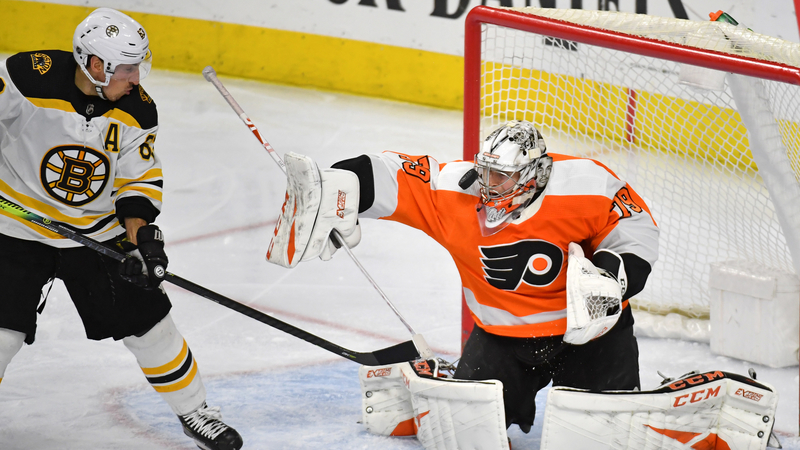 Boston Bruins Left Wing Brad Marchand And Philadelphia Flyers Goalie Carter Hart