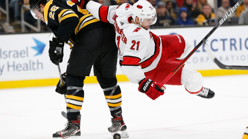 Boston Bruins defenseman Brandon Carlo (25) and Carolina Hurricanes left wing Nino Niederreiter (21)