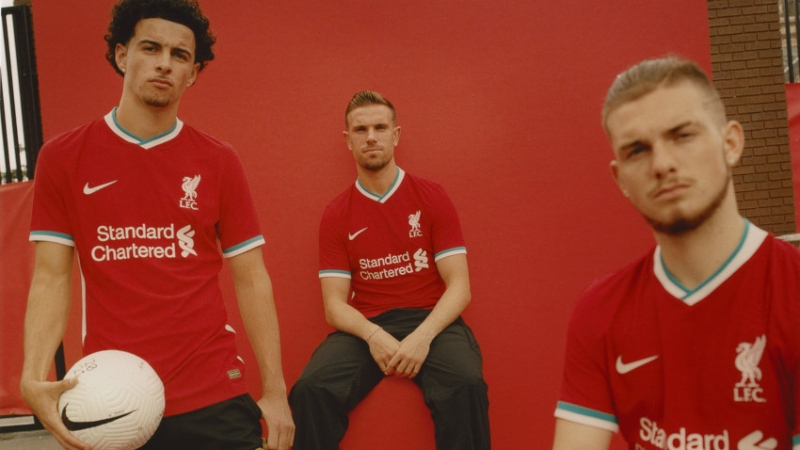 Liverpool midfielders Curtis Jones (left) and Jordan Henderson (center) and forward Harvey Elliot