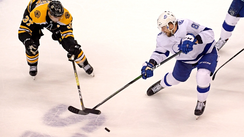 Boston Bruins center Patrice Bergeron (37) and Tampa Bay Lightning defenseman Erik Cernak (81)