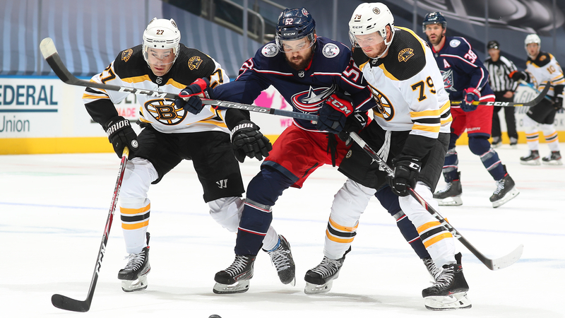 Boston Bruins defensemen John Moore and Jeremy Lauzon, Columbus Blue Jackets forward Emil Bemstrom