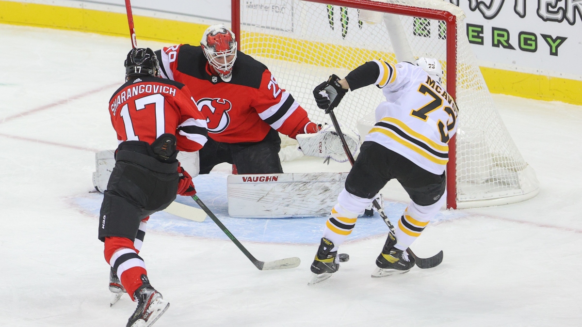 New Jersey Devils goaltender Mackenzie Blackwood (29) and Boston Bruins defenseman Charlie McAvoy (73)