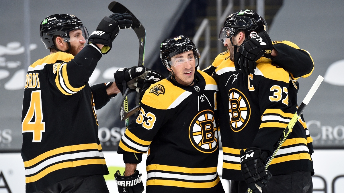 Boston Bruins defenseman Jarred Tinordi (84), left wing Brad Marchand (63) and center Patrice Bergeron (37)