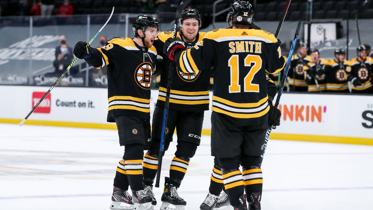 Boston Bruins defensemen Matt Grzelcyk and Charlie McAvoy and center Craig Smith