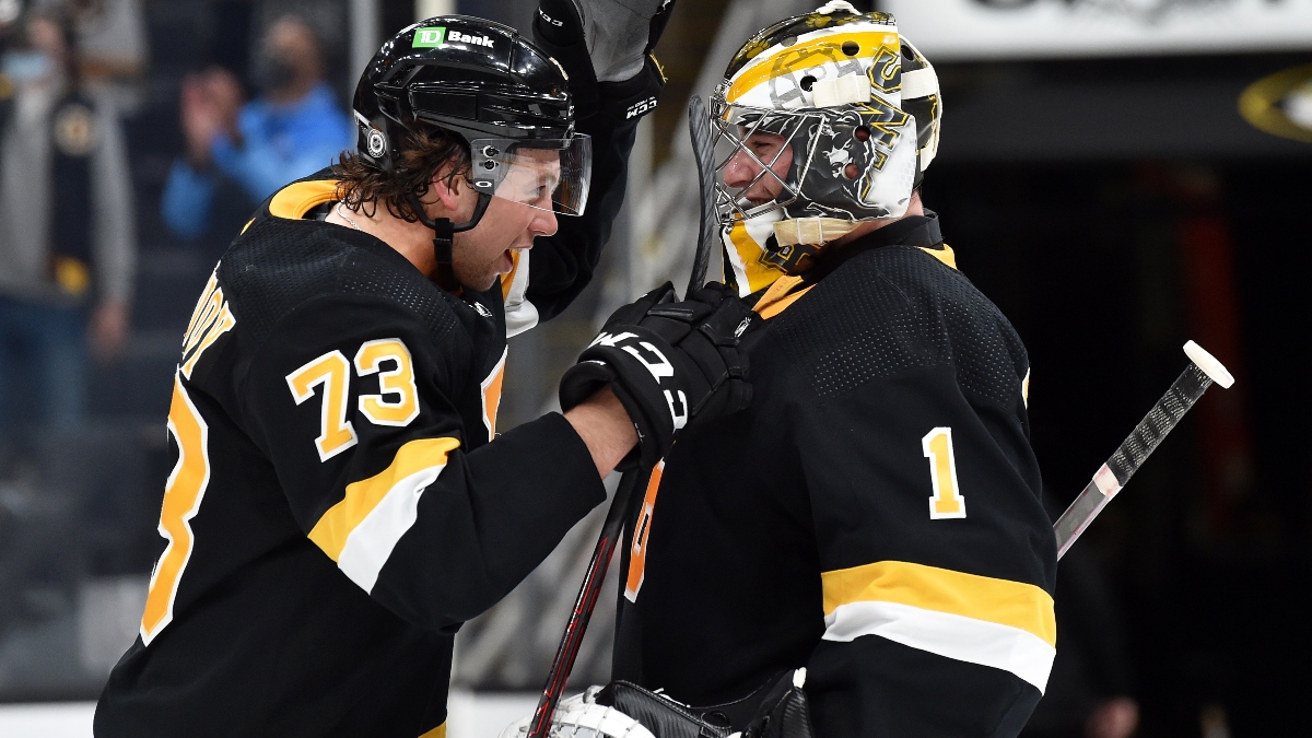 Boston Bruins defenseman Charlie McAvoy (73) and goaltender Jeremy Swayman (1)