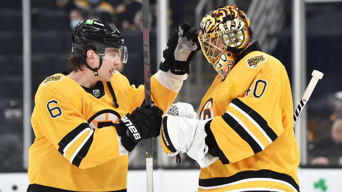 Boston Bruins defenseman Mike Reilly, goaltender Tuukka Rask