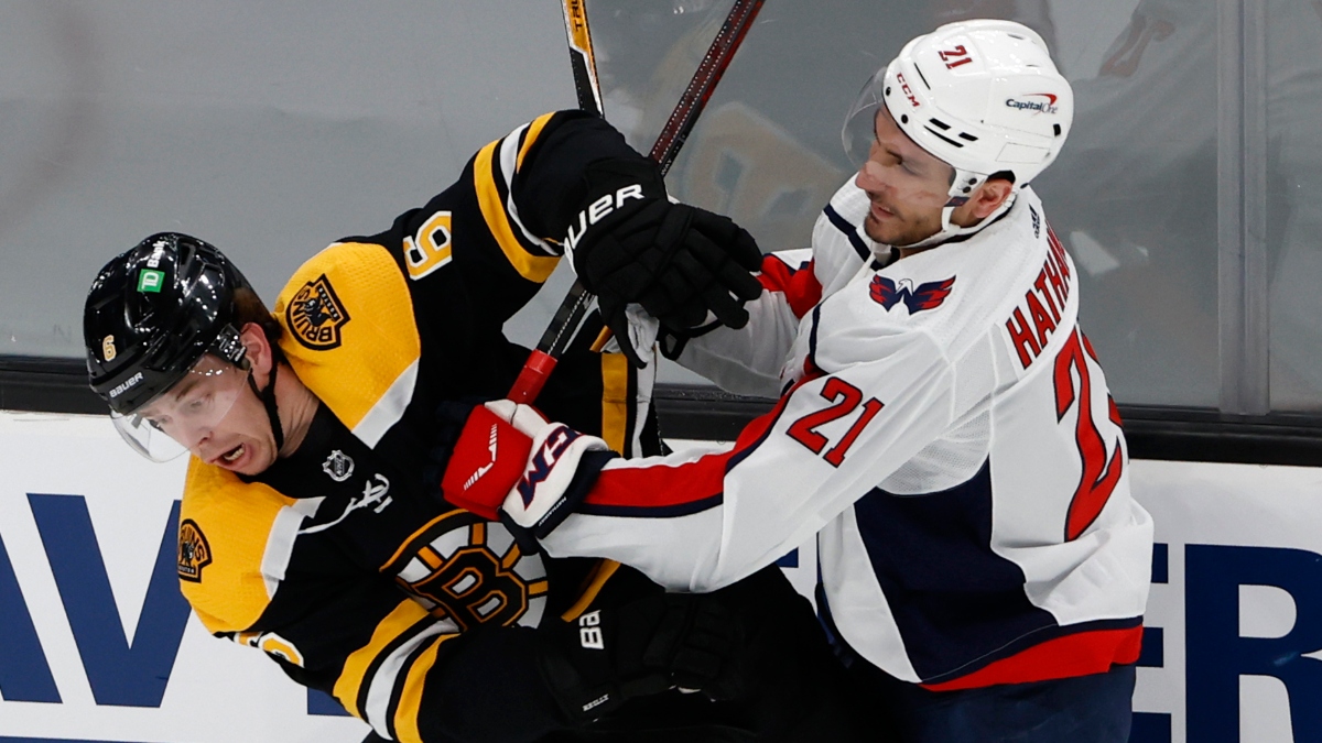 Washington Capitals right wing Garnet Hathaway (21) and Boston Bruins defenseman Mike Reilly (6)