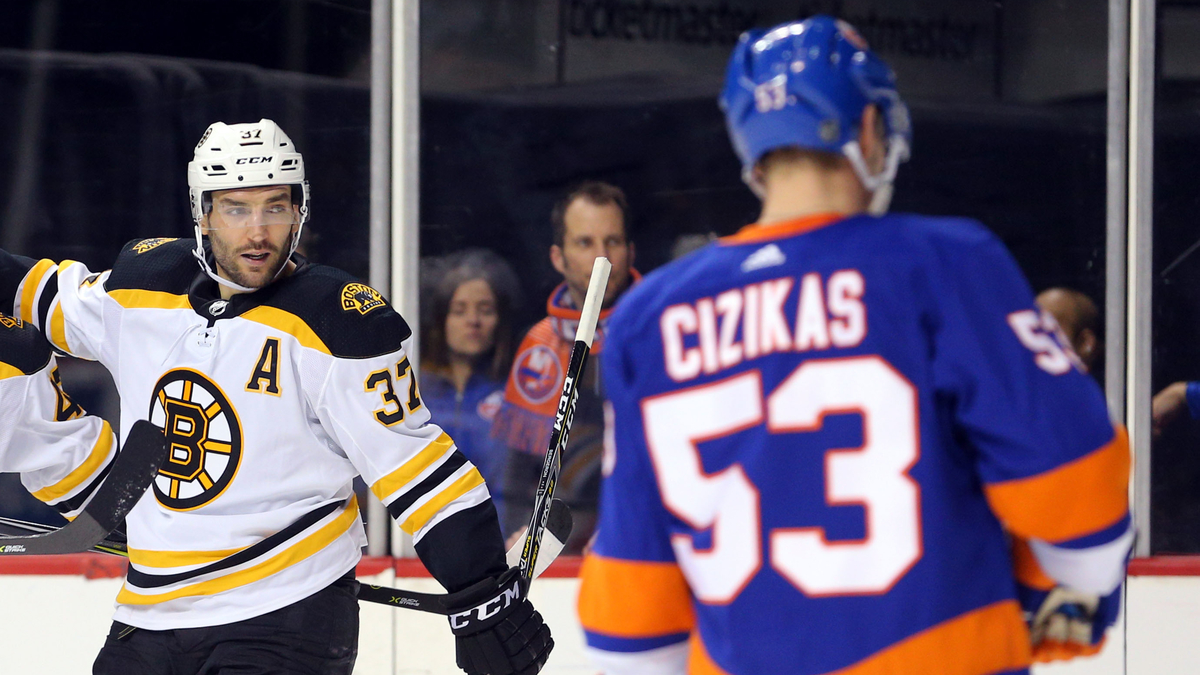 Boston Bruins center Patrice Bergeron, New York Islanders center Casey Cizikas
