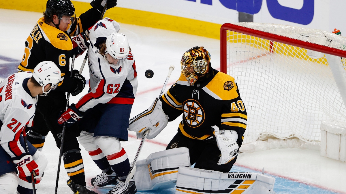 Boston Bruins goaltender Tuuka Rask (right) and Washington Capitals left wing Carl Hagelin (62)