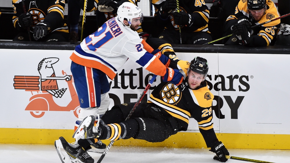 New York Islanders right wing Kyle Palmieri (21) and Boston Bruins defenseman Brandon Carlo (25)