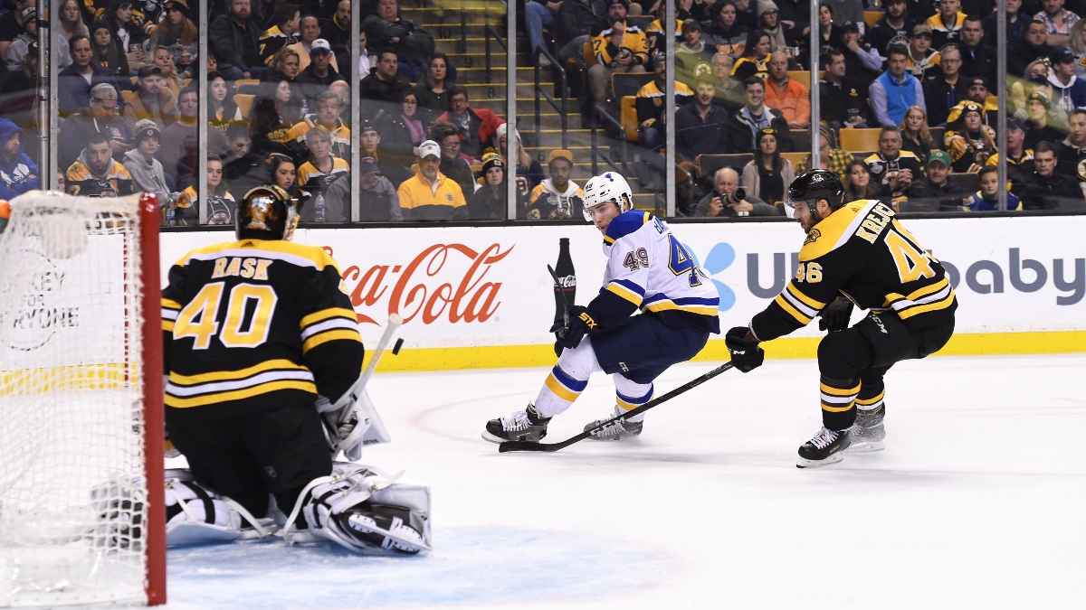 St. Louis Blues center Ivan Barbashev (49), Boston Bruins goaltender Tuukka Rask (40) and center David Krejci (46)