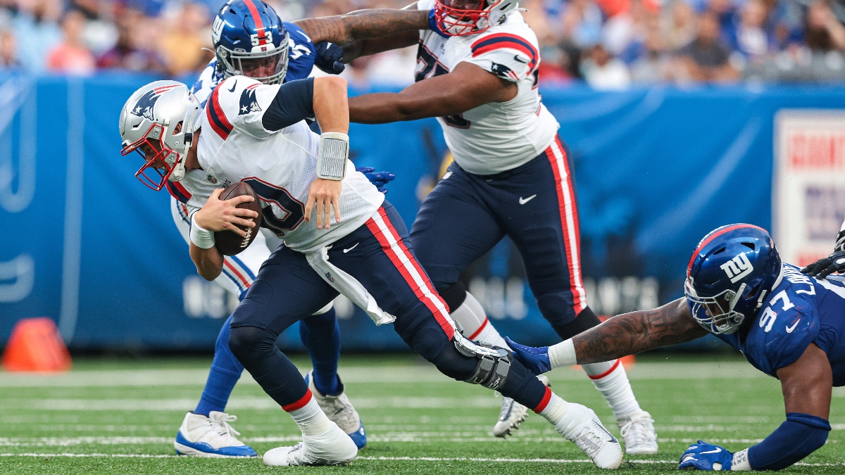 New England Patriots quarterback Mac Jones and New York Giants defensive tackle Dexter Lawrence (97)