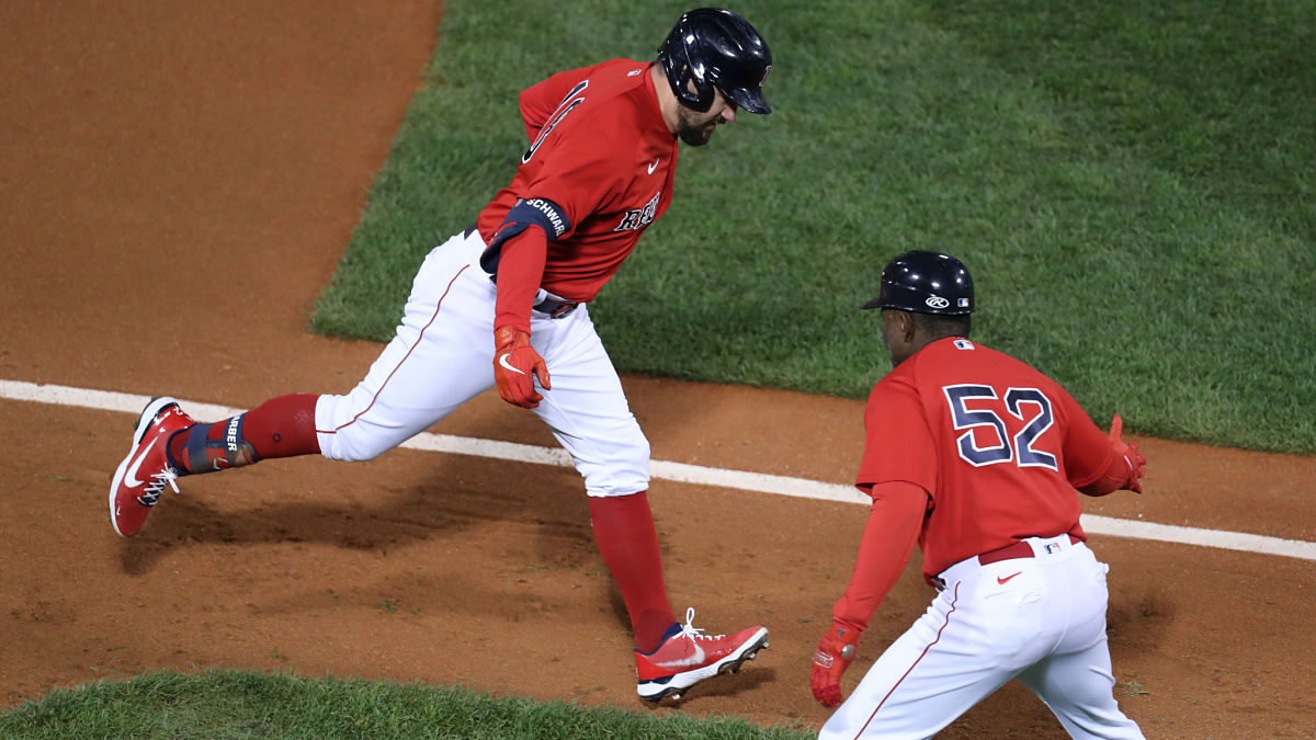 Boston Red Sox first baseman Kyle Schwarber and third base coach Carlos Febles