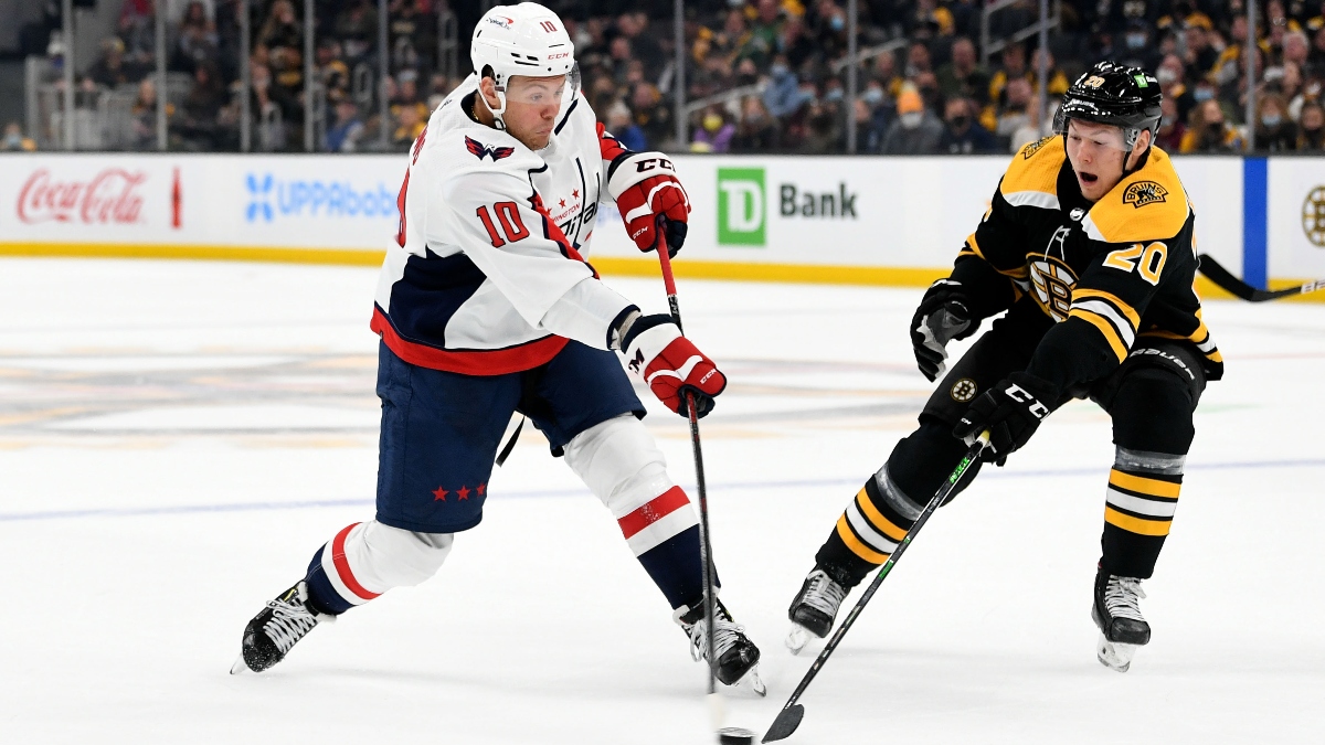 Washington Capitals right wing Daniel Sprong (10) and Boston Bruins center Curtis Lazar (20)