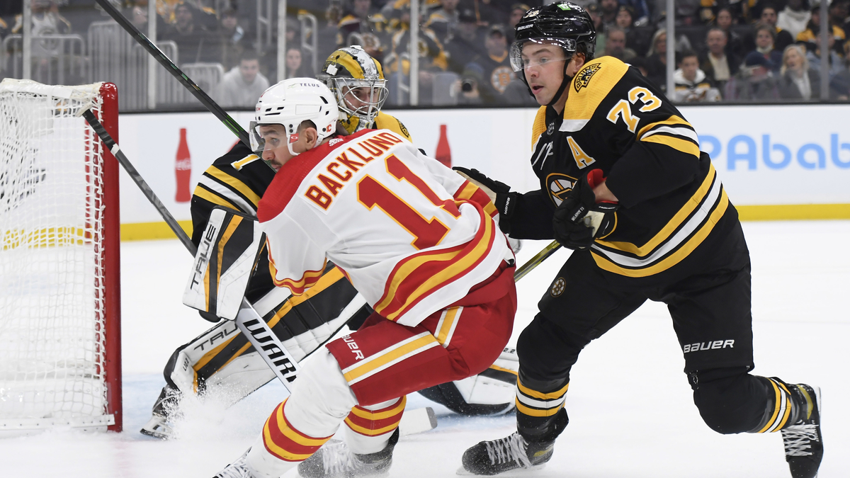 Calgary Flames forward Mikael Backlund, Boston Bruins defenseman Charlie McAvoy