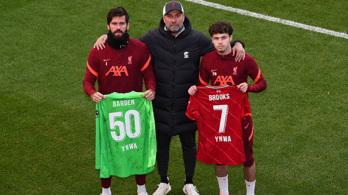 Liverpool FC goalkeeper Allison Becker, coach Jurgen Klopp, defender Neco Williams