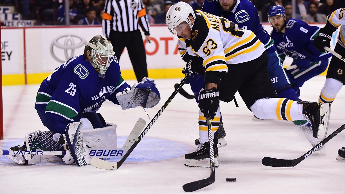 Boston Bruins forward Brad Marchand (63) and Vancouver Canucks players