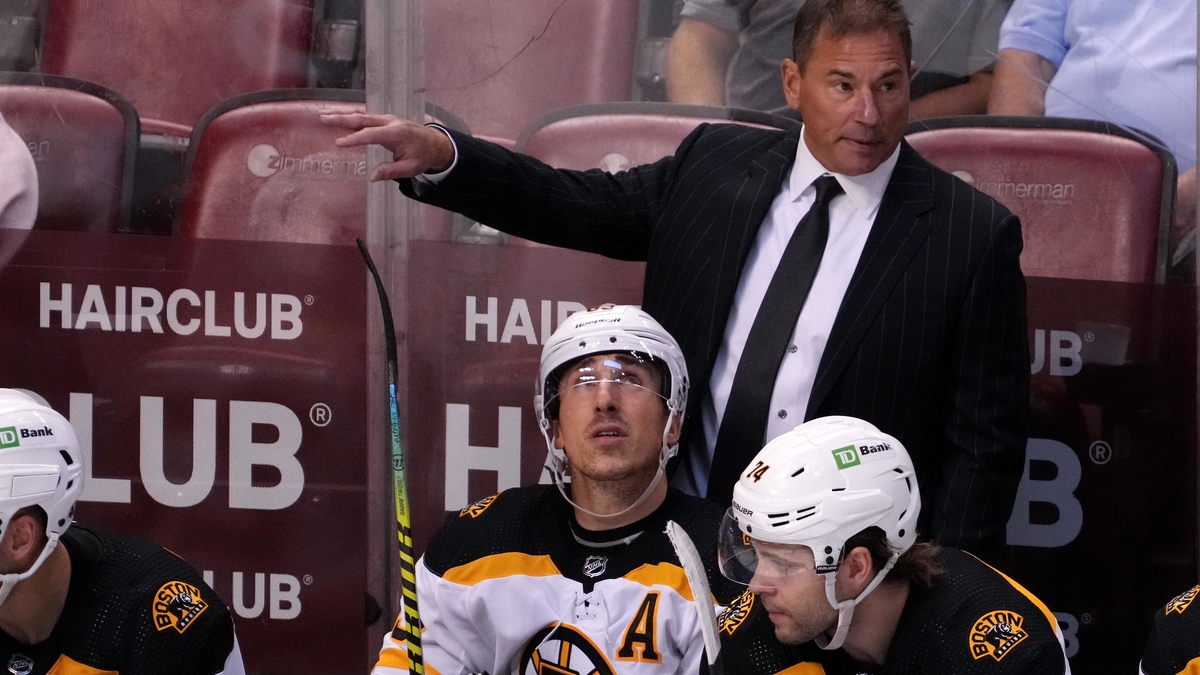 Boston Bruins head coach Bruce Cassidy, wingers Brad Marchand, Jake DeBrusk