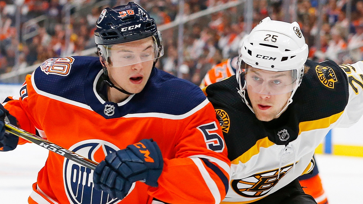 Edmonton Oilers forward Kailer Yamamoto (56) and Boston Bruins defensemen Brandon Carlo (25)